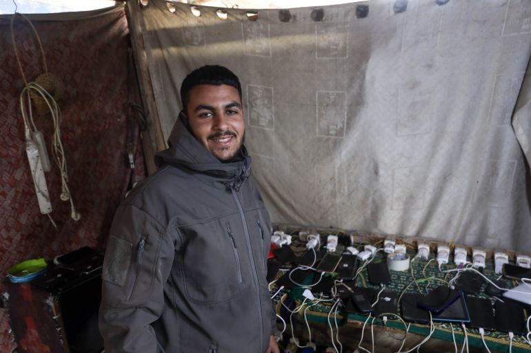 Gaza families rely on phone lamps as war destroys power grid.